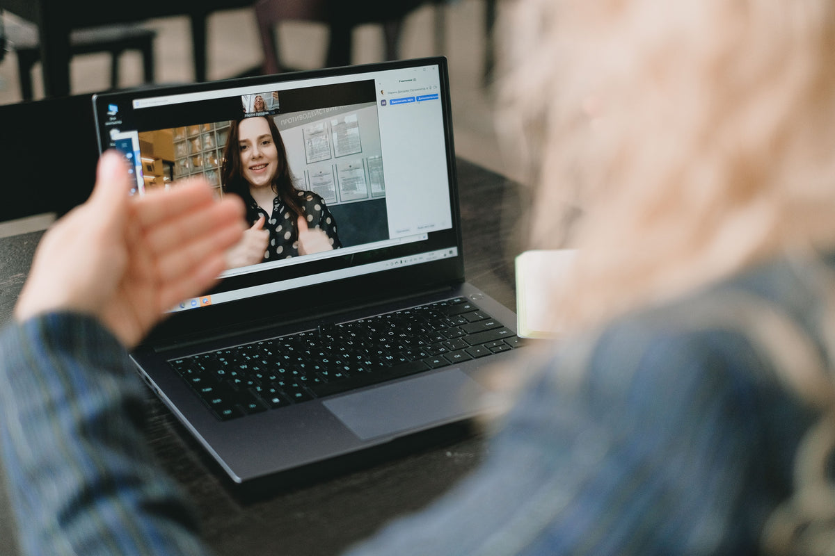 A woman meets with her colleague on a video call