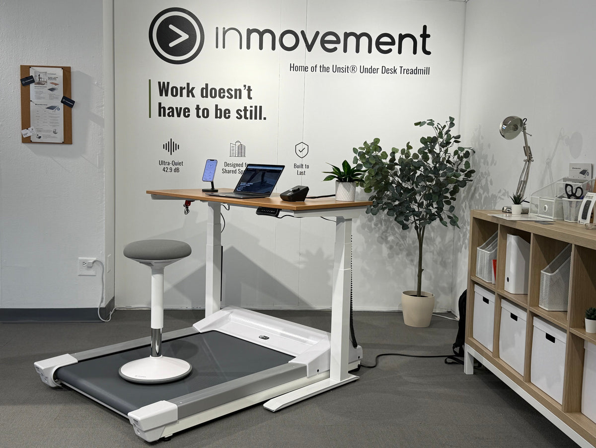 Office setup with treadmill desk and 'inmovement' branding, showing the Energy Stool paired with the treadmill desk workstation
