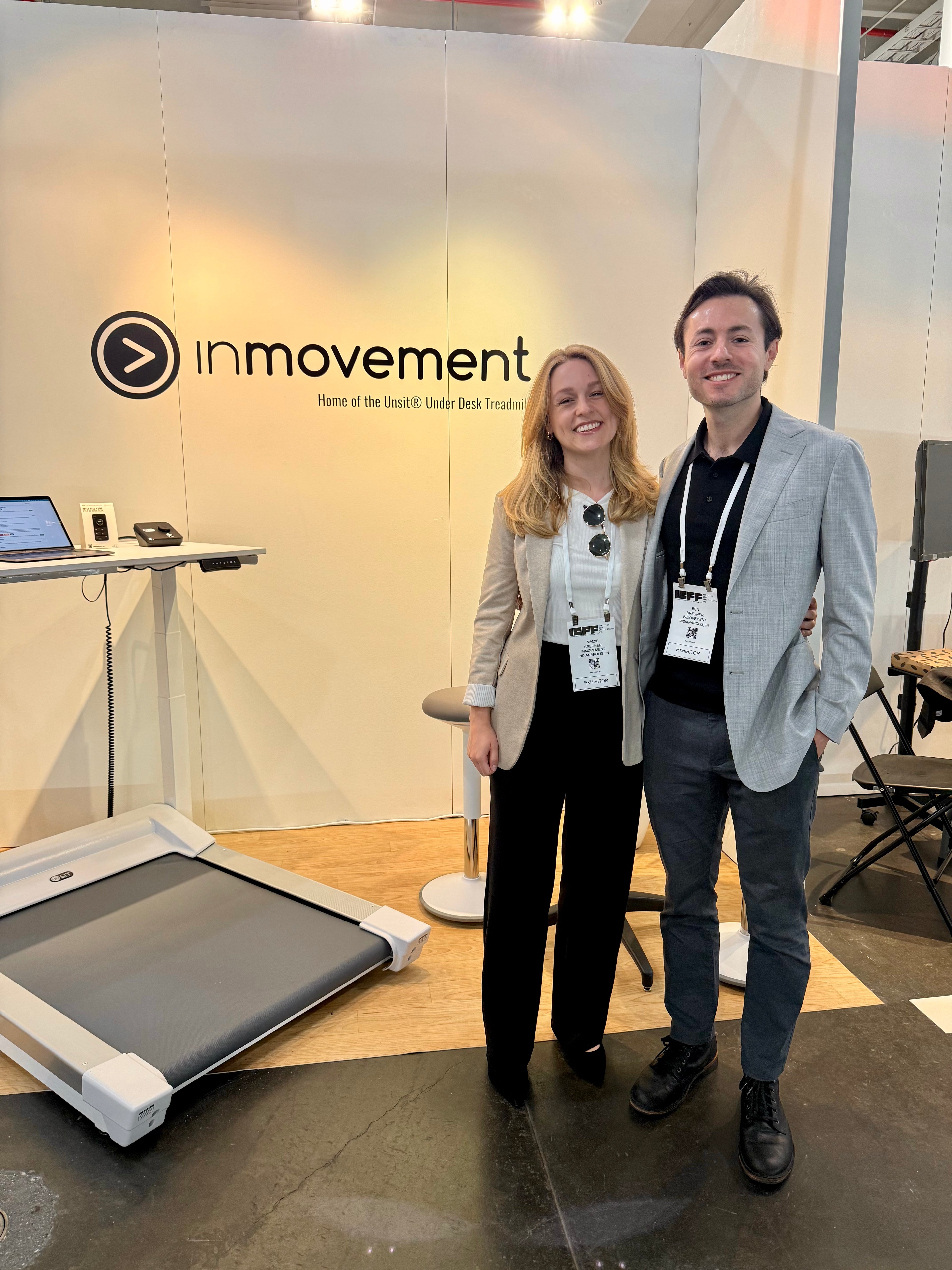InMovement owners stand in front of their InMovement booth at an expo