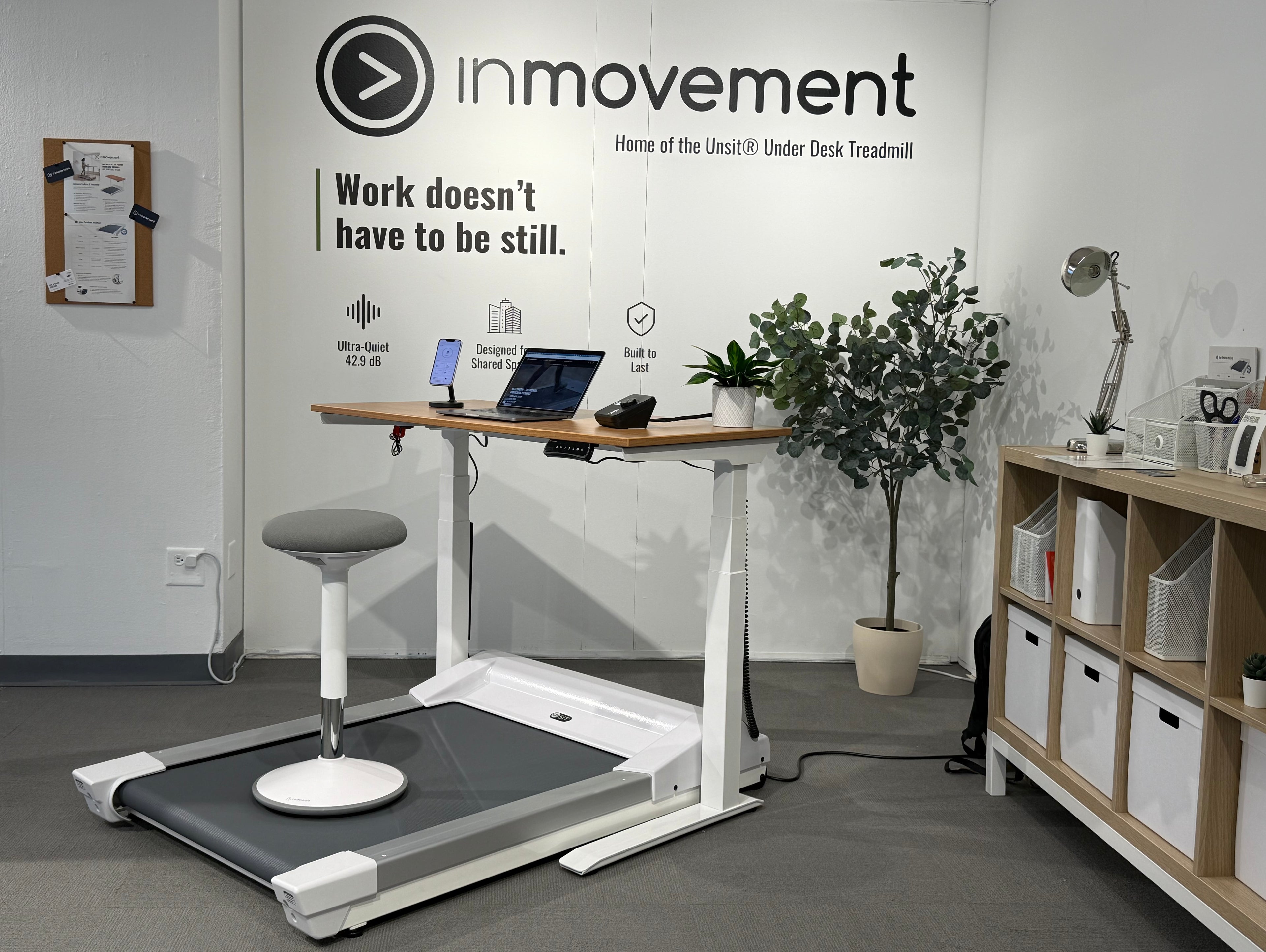 Office setup with treadmill desk and 'inmovement' branding, showing the Energy Stool paired with the treadmill desk workstation